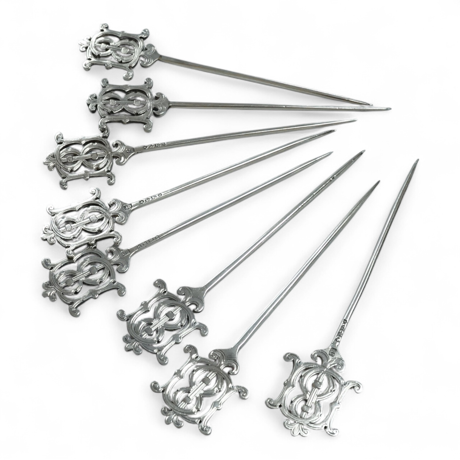 A set of eight Victorian silver game skewers?, with monogram terminals, Jane Brownett, London, 1877, 12,8cm.